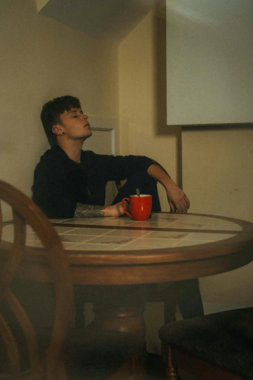 a man sits at a table in the midst of a conversation