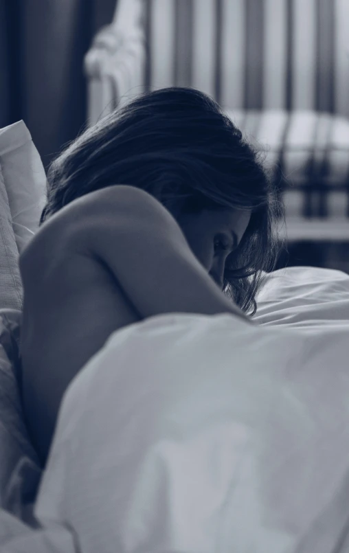 a  woman sitting on a bed reading a book