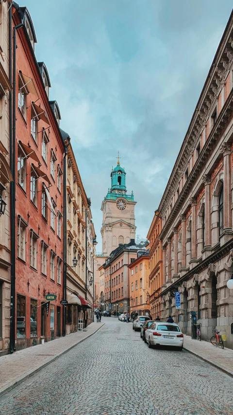 the old buildings are along side the cobblestone road