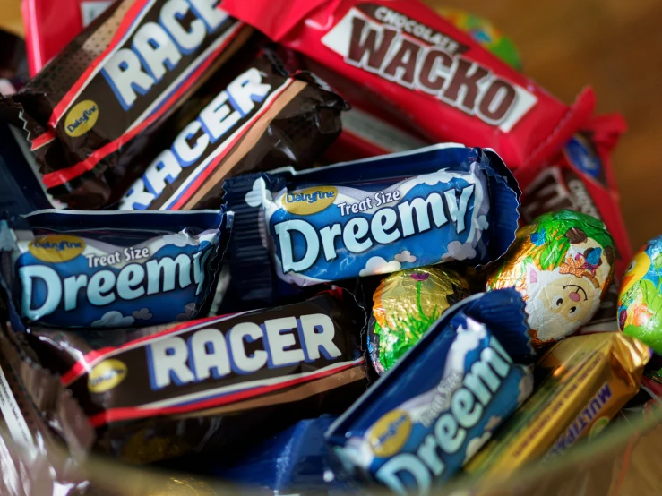 a bowl filled with assorted chocolate wrapped candy