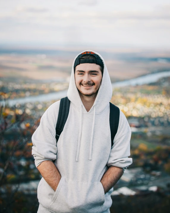 a man posing for a po in front of a valley