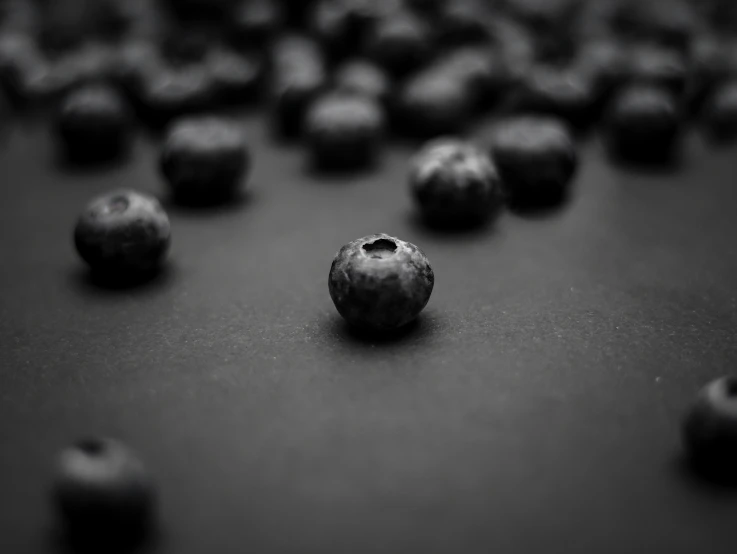 several large and small blueberries laying on top of each other