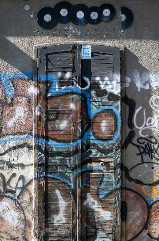 a wooden door and some graffiti on a wall