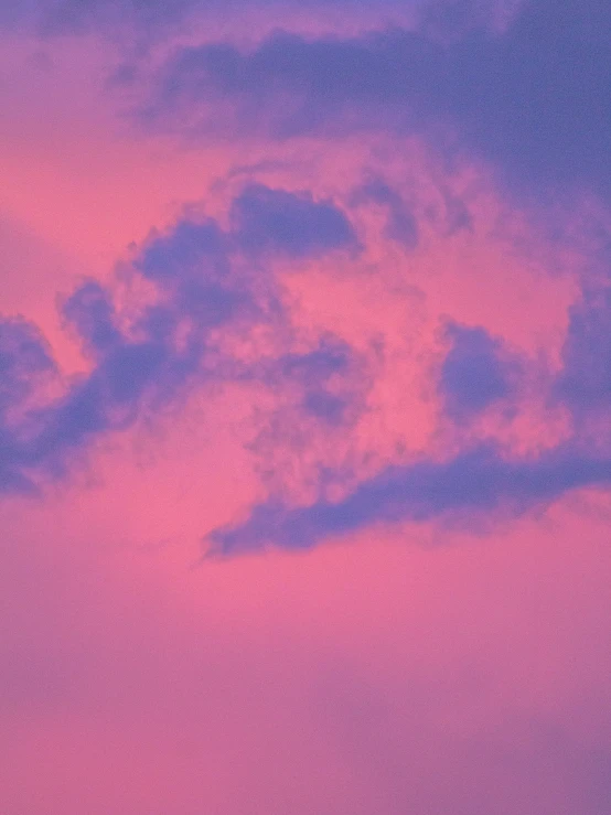 the sky is pink and blue at sunset