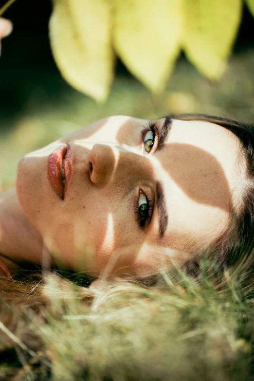 woman laying on the ground posing for a portrait