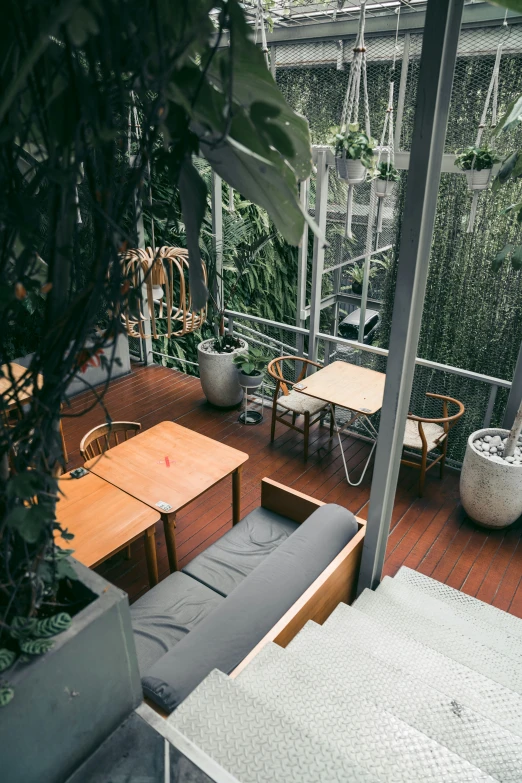 the balcony is decorated with various plants and furniture