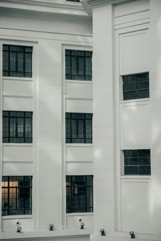 a white building with black windows and bars on it