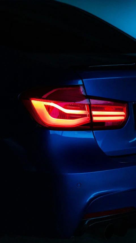 the tail light of an automobile in a dark place