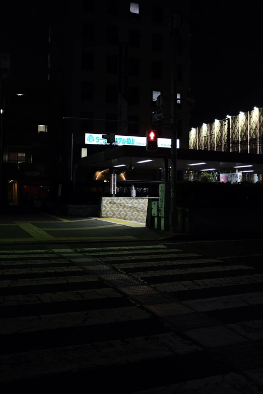 a view of a night scene, with the traffic light shining down