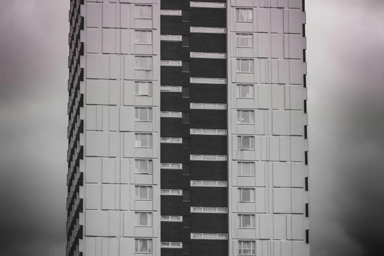 the tall building is made out of windows and black shutters