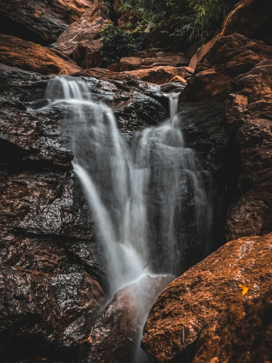 a waterfall cascading down some rocky sides