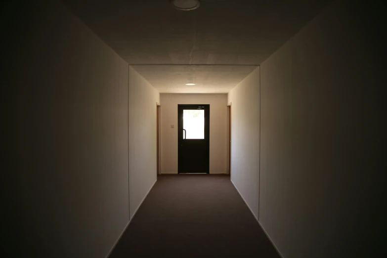 a narrow hallway is lit by bright light