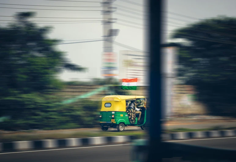 a motor tricycle sitting on the side of the road