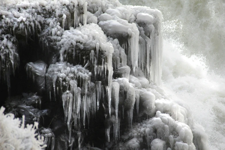 a wall of ice on a river by the shore