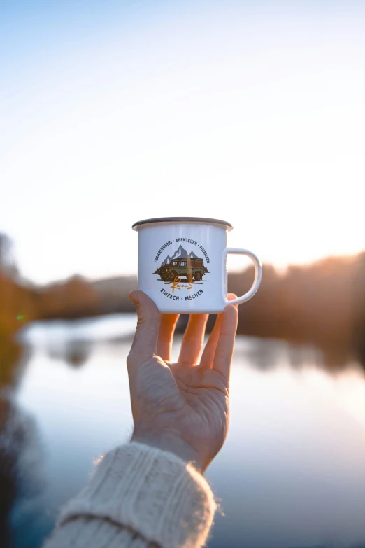 a person holding a mug in their hand