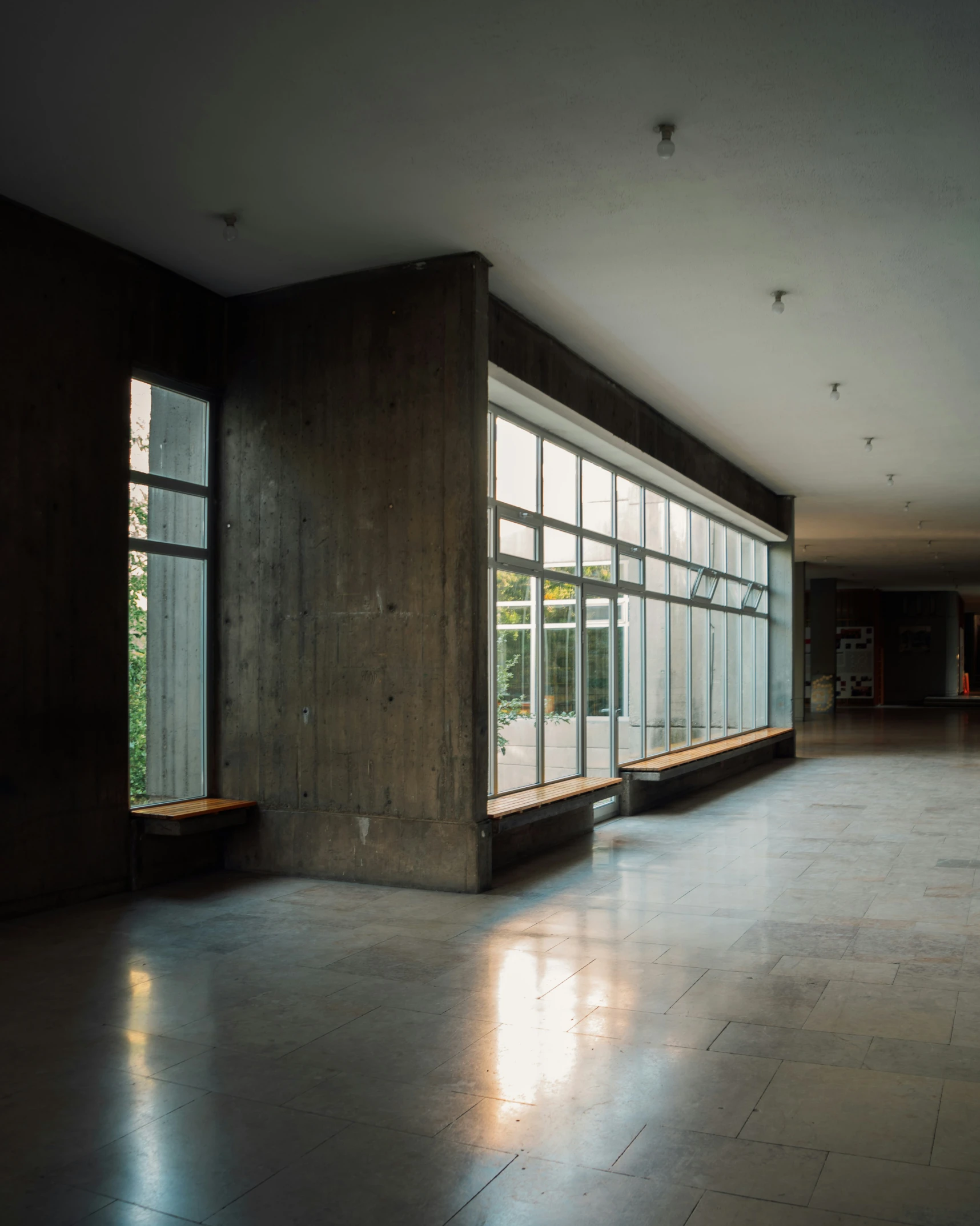 the inside of an empty building has large windows