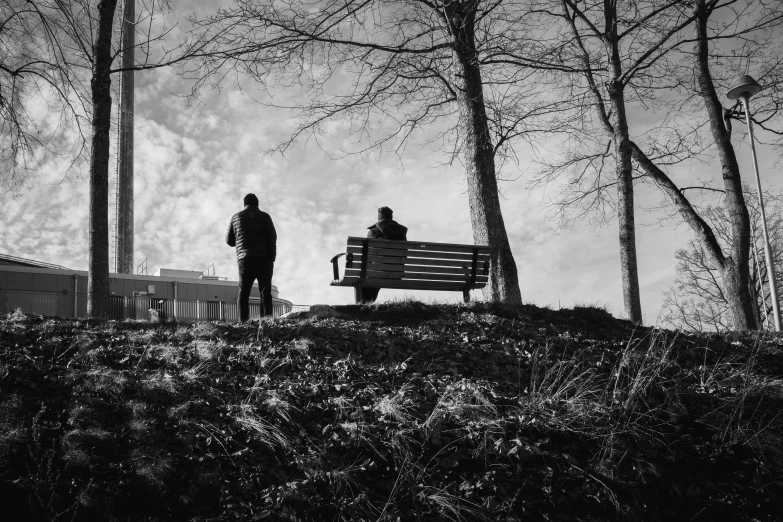 a couple of people that are standing on a bench