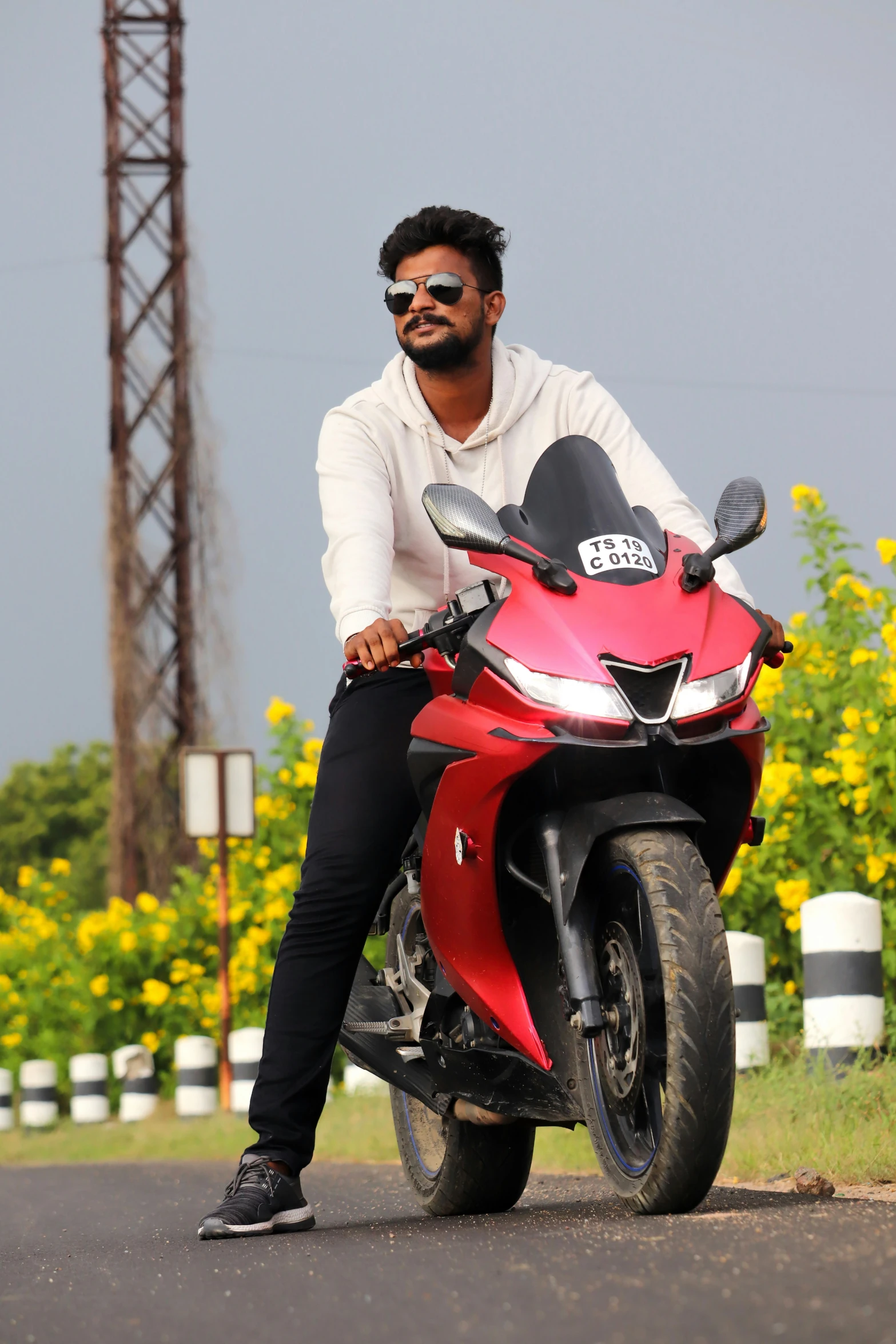 a man sitting on a red motor bike