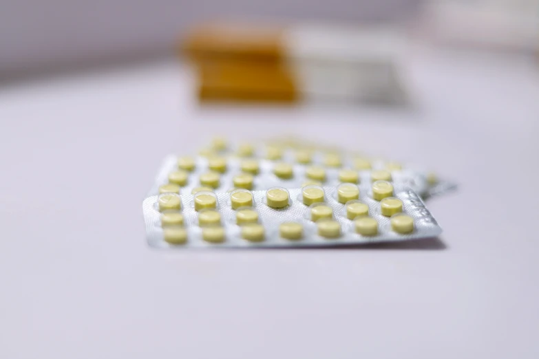 a close up of two pills placed on top of the table