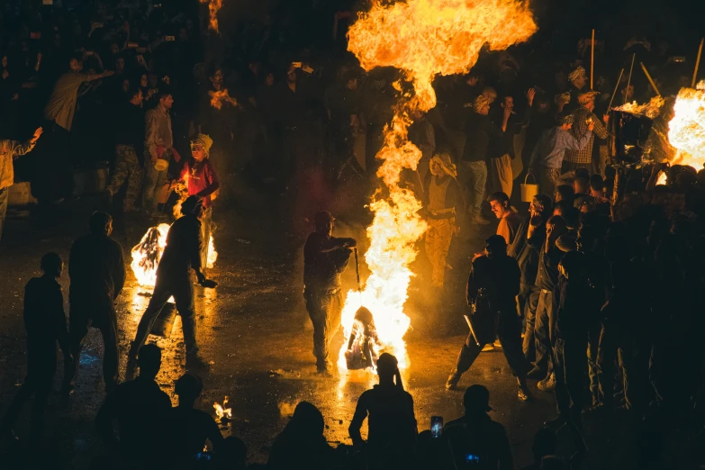 fire flames dancing in front of a group of people