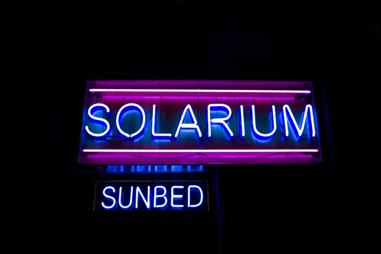the neon signs are blue and read solarium