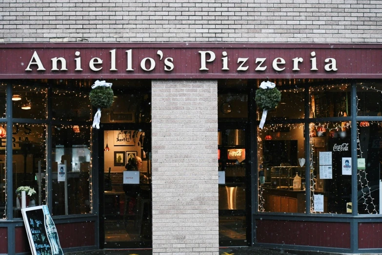 a large windowed store with a brick building behind it