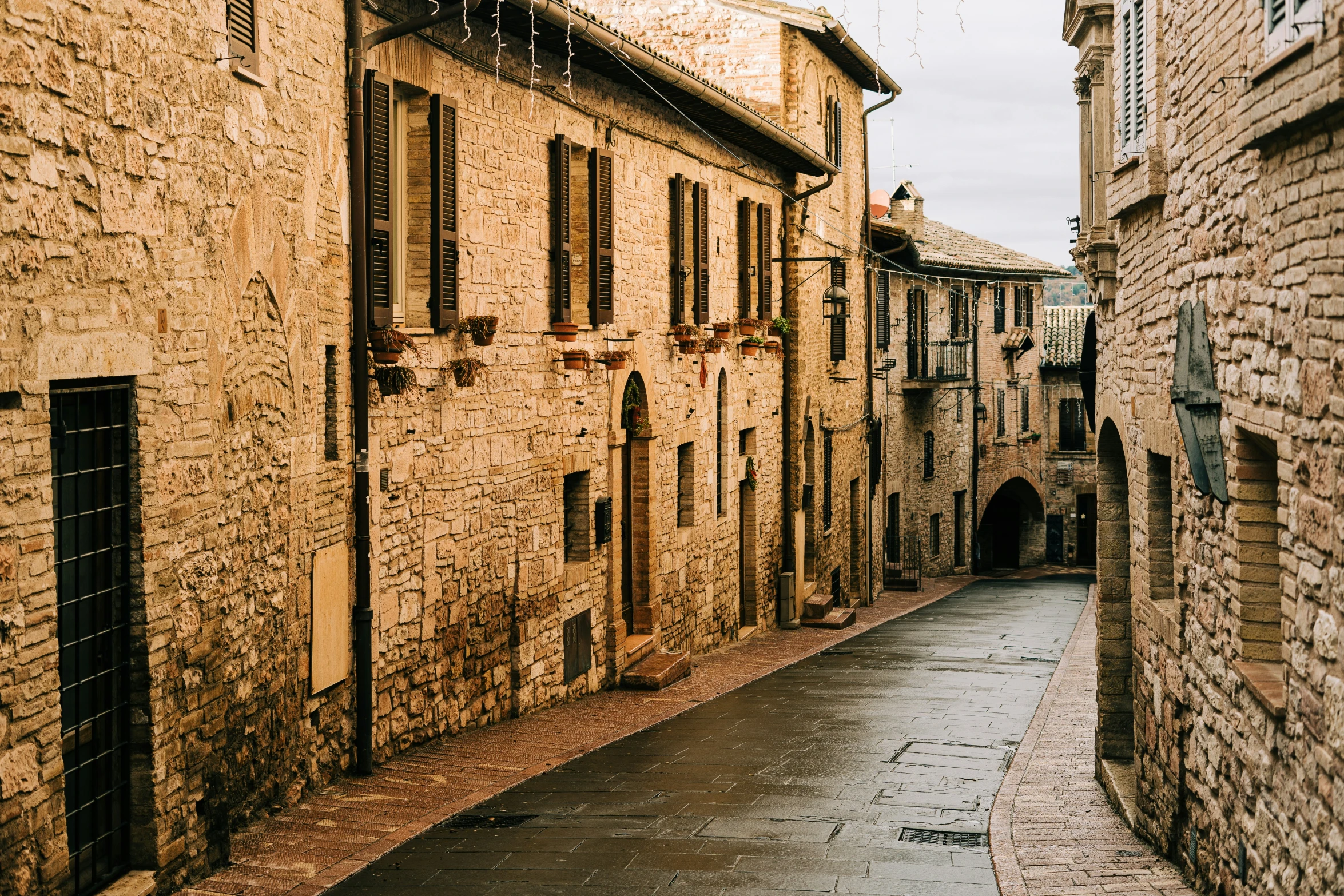 an old alley way leading to some very tall buildings