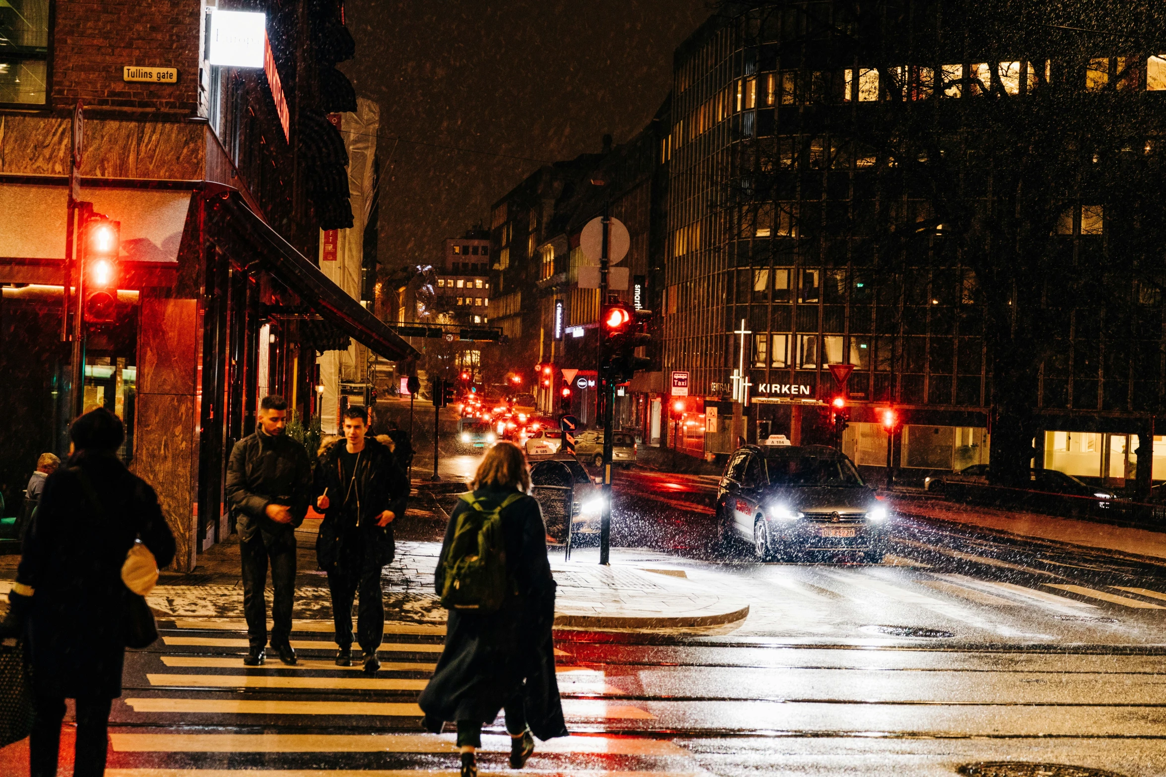 the people are crossing the street in the rain