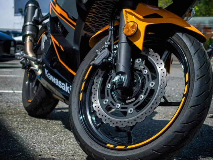 an orange motorcycle parked in a parking lot