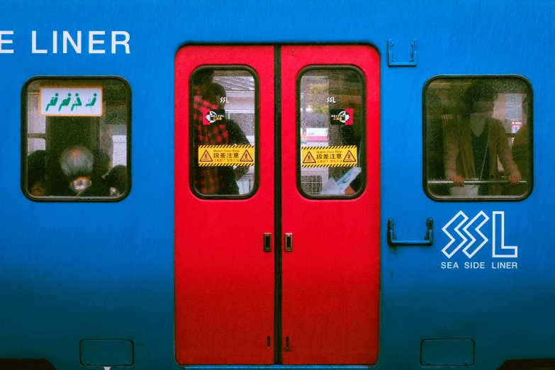 the inside of a colorful passenger train that is blue and red