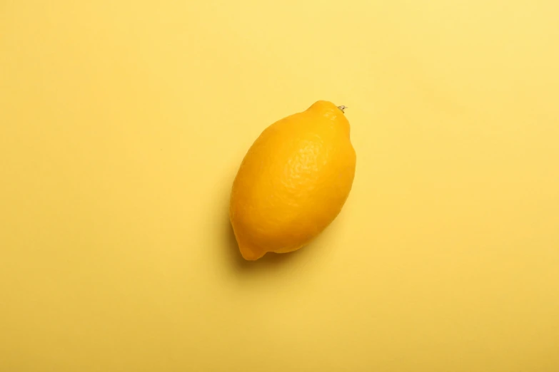 there is a yellow lemon on the table