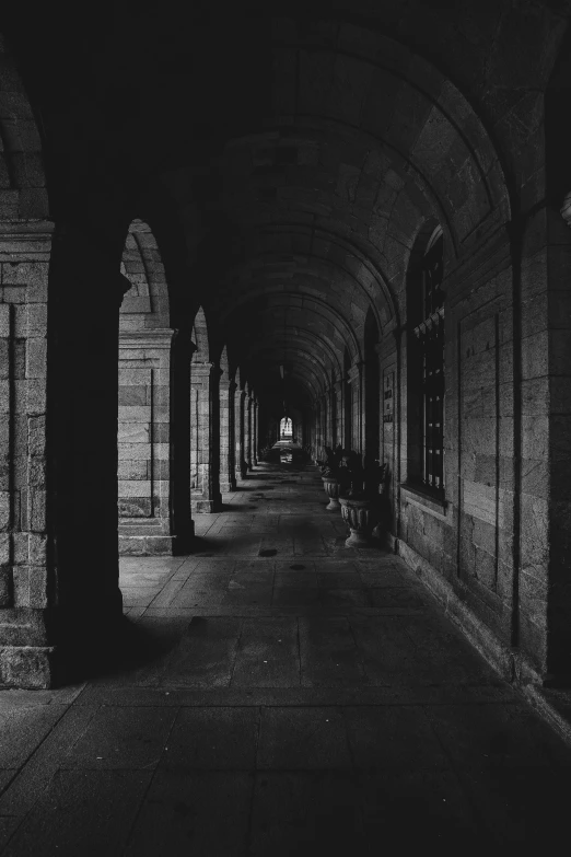 a dimly lit room with arches and arched doorways
