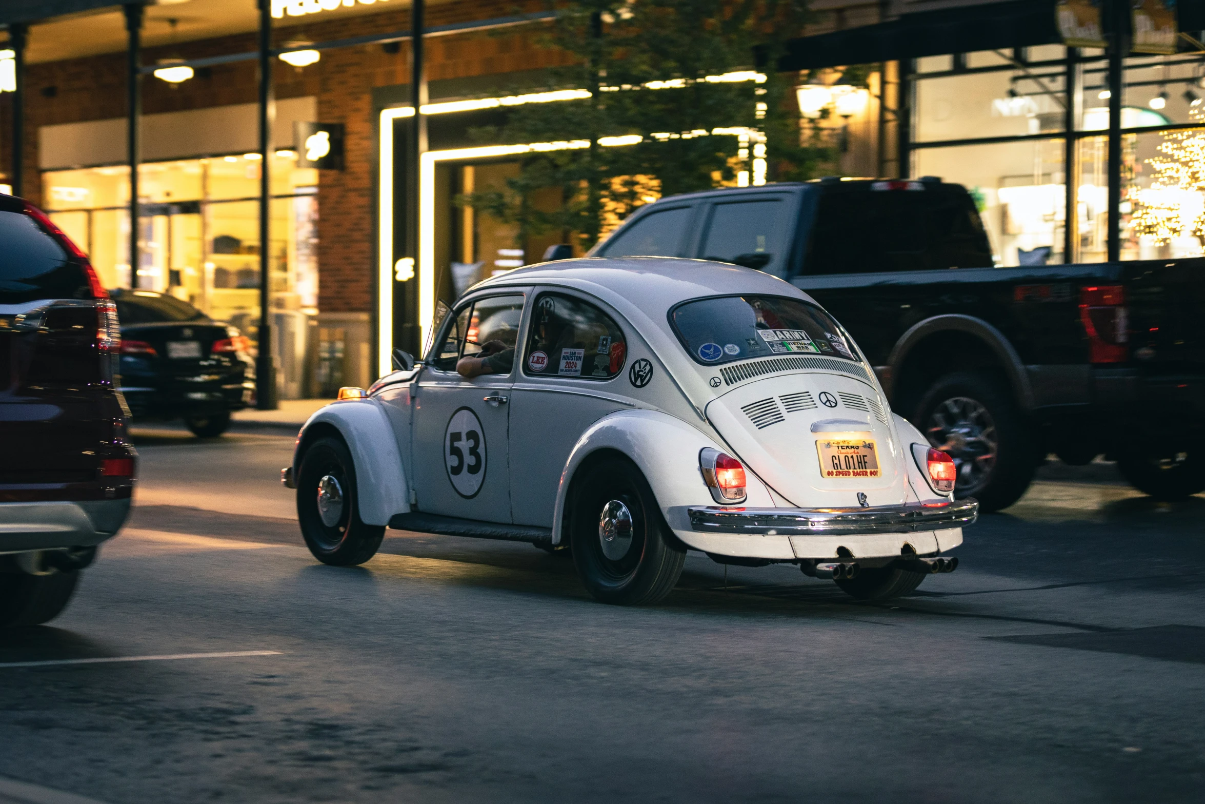 a small vw bug driving down the street