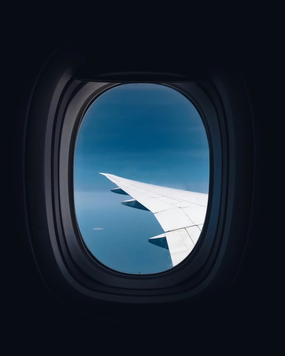 looking out an airplane window at the outside of the plane's wing