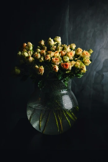 yellow and pink flowers are arranged in a glass vase
