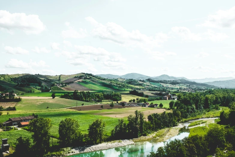 an aerial view of the river and the green hills