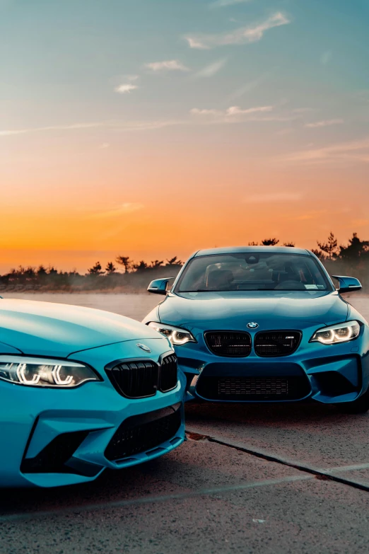 two cars parked side by side in front of a sky background