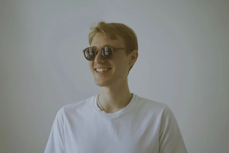 a guy with shades on his eyes smiling