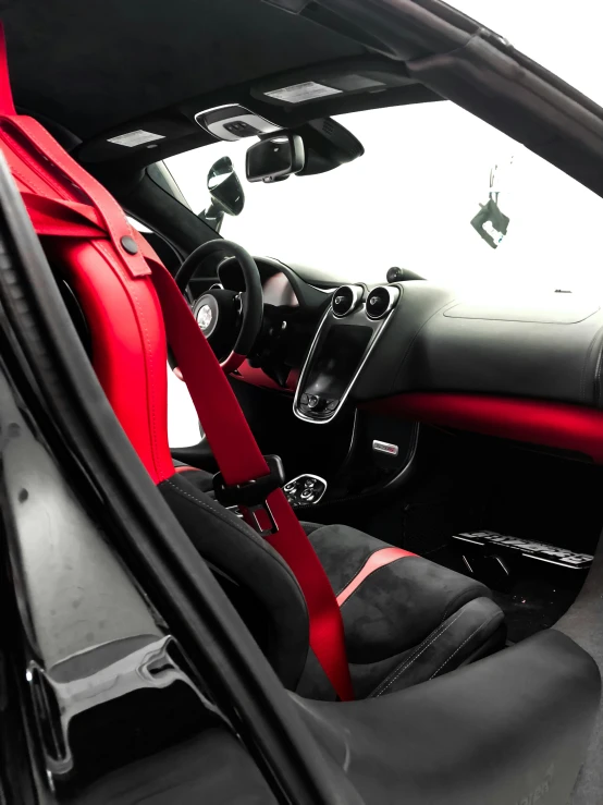 the interior of a black and red sports car