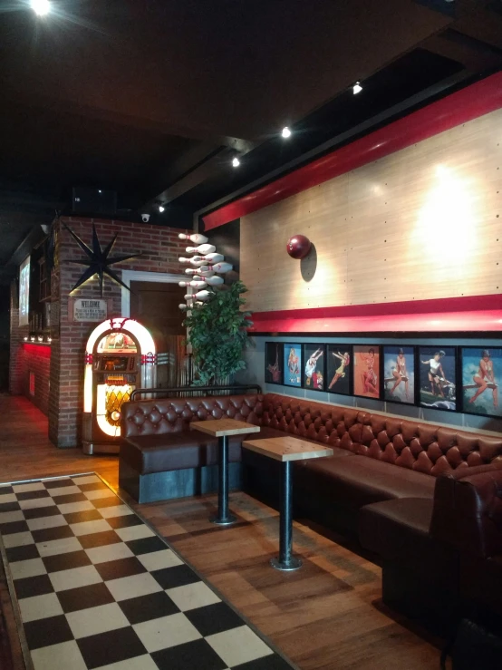 a view of a restaurant with checkered floor and booths