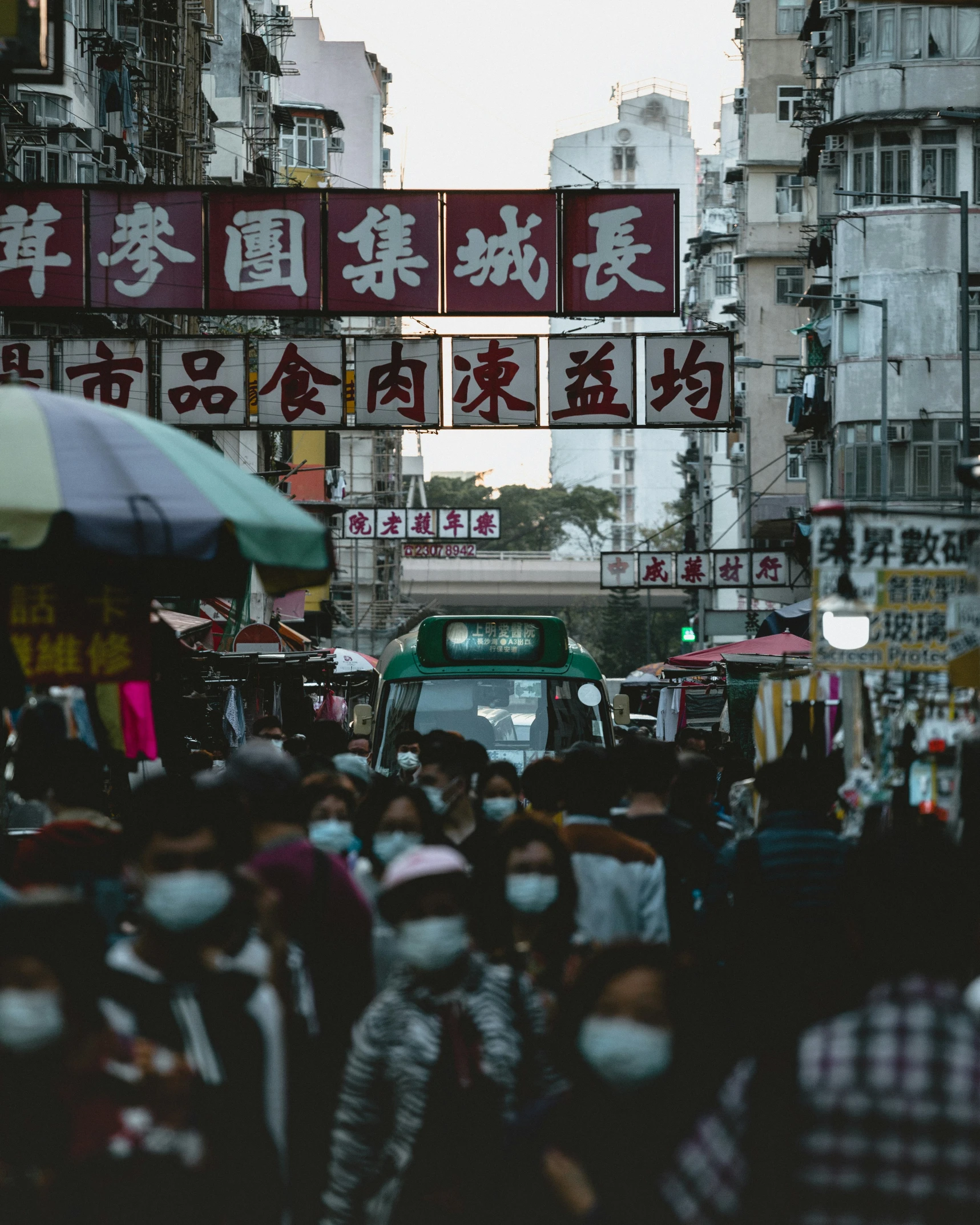 many people and trucks on a busy street