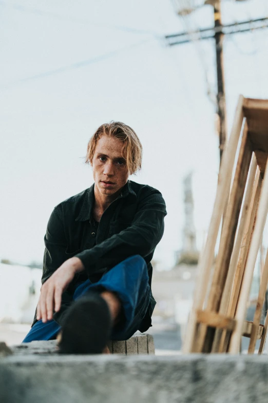 a man sitting on a ledge outside of a building