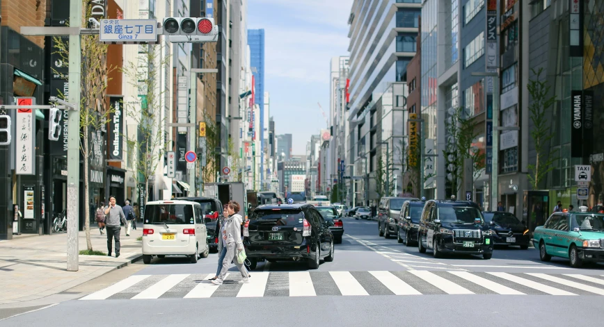 a person crossing the street in front of cars