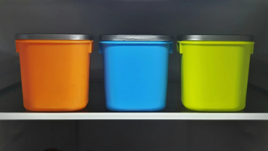 three different colored plastic cups are shown here