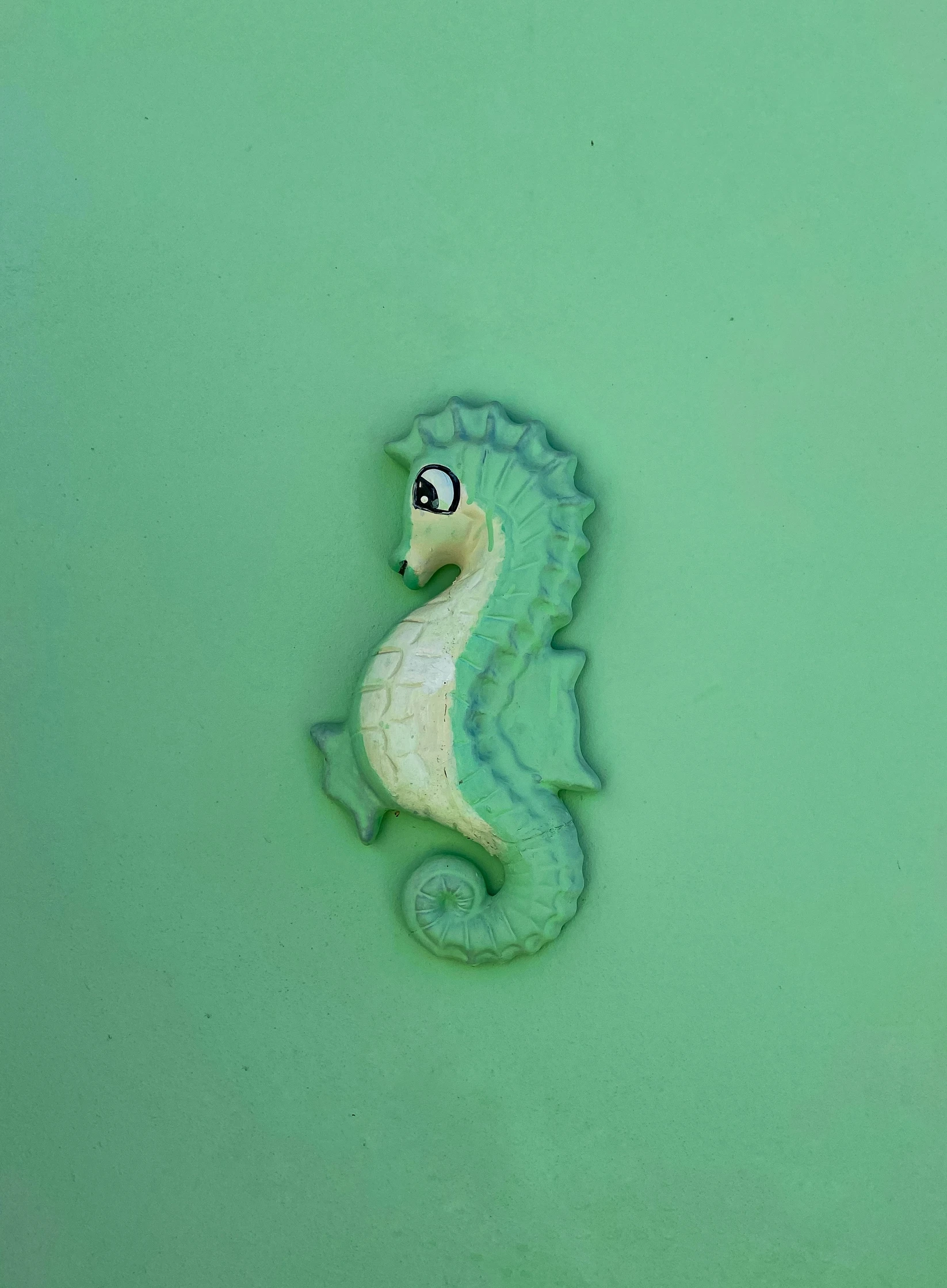 a very cute little seahorse on the green water