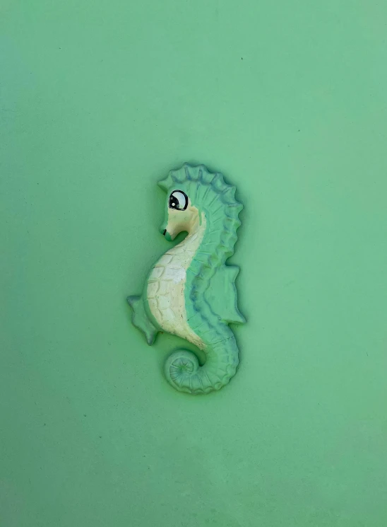 a very cute little seahorse on the green water