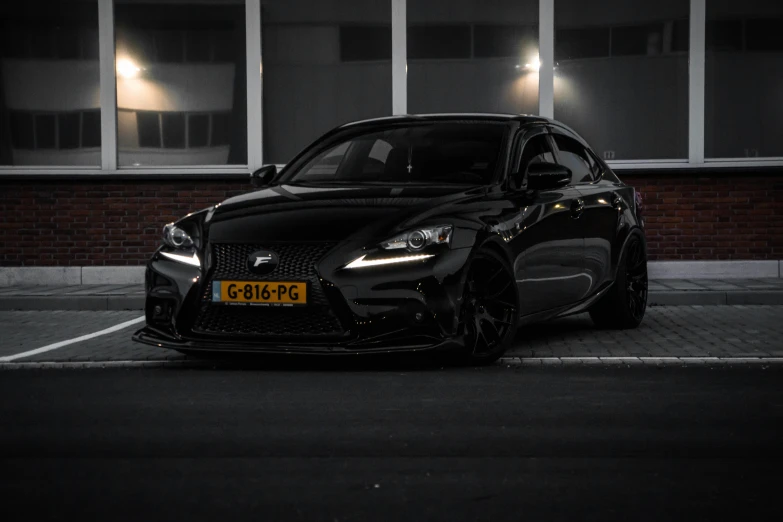 this is a black sports car parked in front of a building