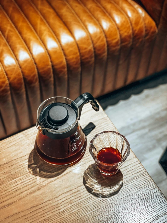 a glass and brown chair on a table