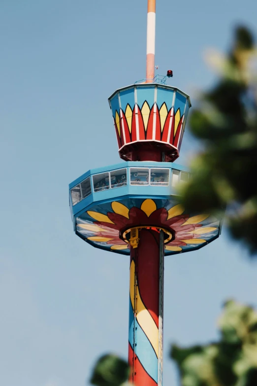 the top of a ride is designed to look like a carnival ferris wheel