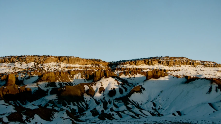 a snowy mountain with trees and snow covered mountains